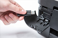 black inkjet printer with hand inserting USB stick - MFC-J890DW