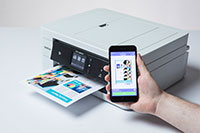 White printer printing colourful document from mobile device