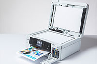White inkjet printer printing colourful document with copier lid open - MFC-J985DW