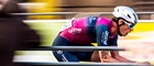 Cyclist from Brother UK backed, Crimson Performance team, riding past spectators in a blur