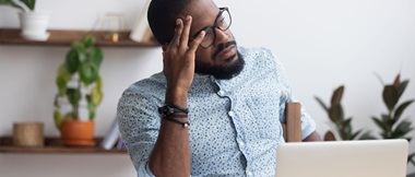 Serious thoughtful businessman sitting at desk