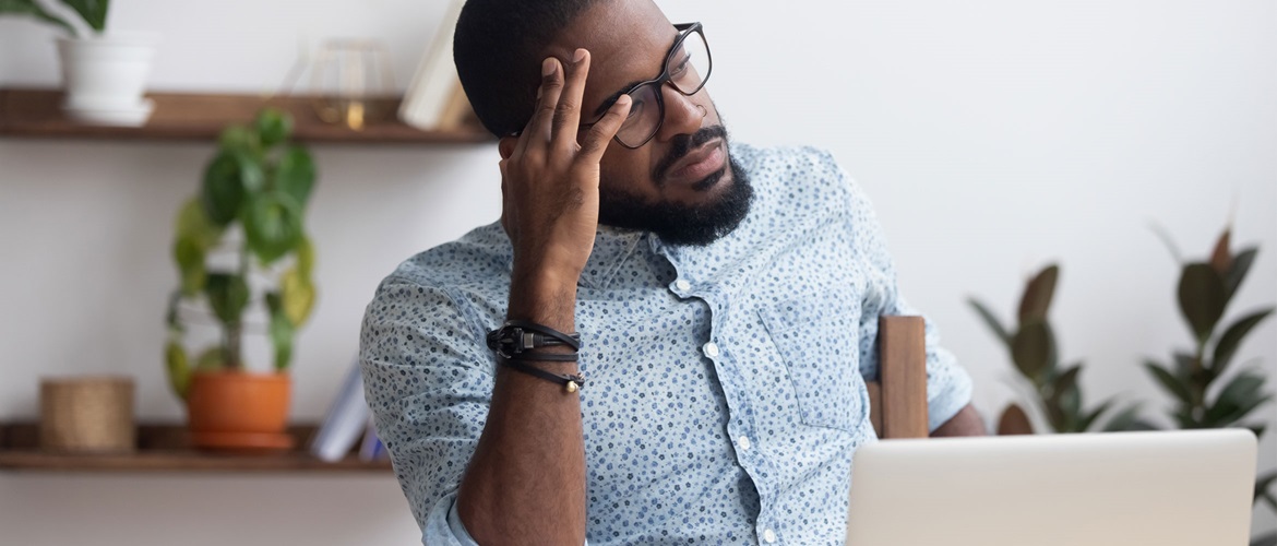 Serious thoughtful businessman sitting at desk