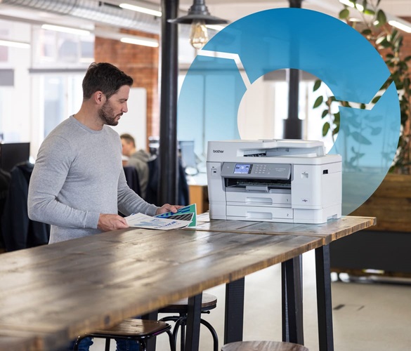 A man using an inkjet printer in an SMB environment with a circular process graphic in the background