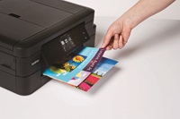 Person removing colour prints from Brother printer