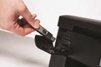 Person inserting USB flash drive into Brother printer
