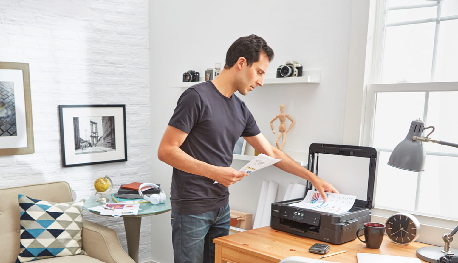 Man at home scanning documents using a brother device