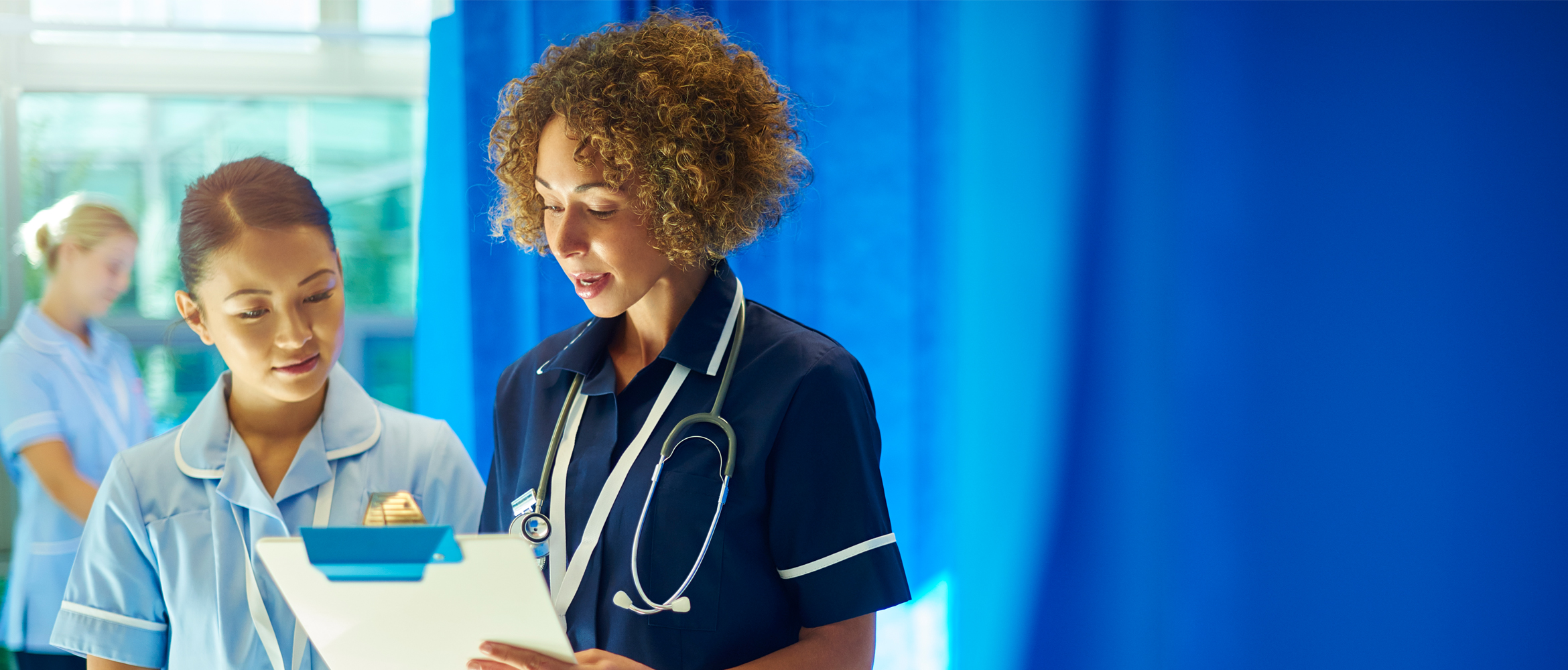 Two healthcare professionals reading results